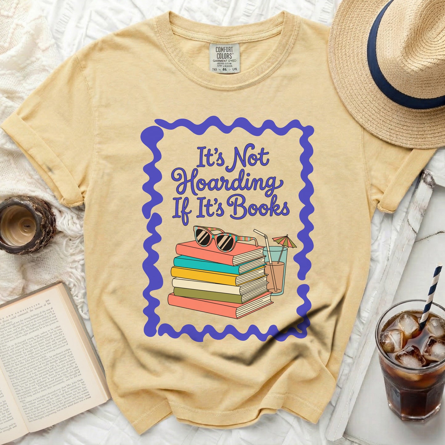 Yellow t-shirt with "It's Not Hoarding If It's Books" and stacked books graphic.