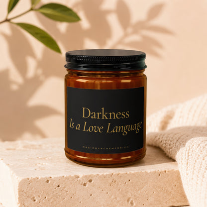 Candle with black label reading "Darkness Is a Love Language" and "MagicMerchEmporium".