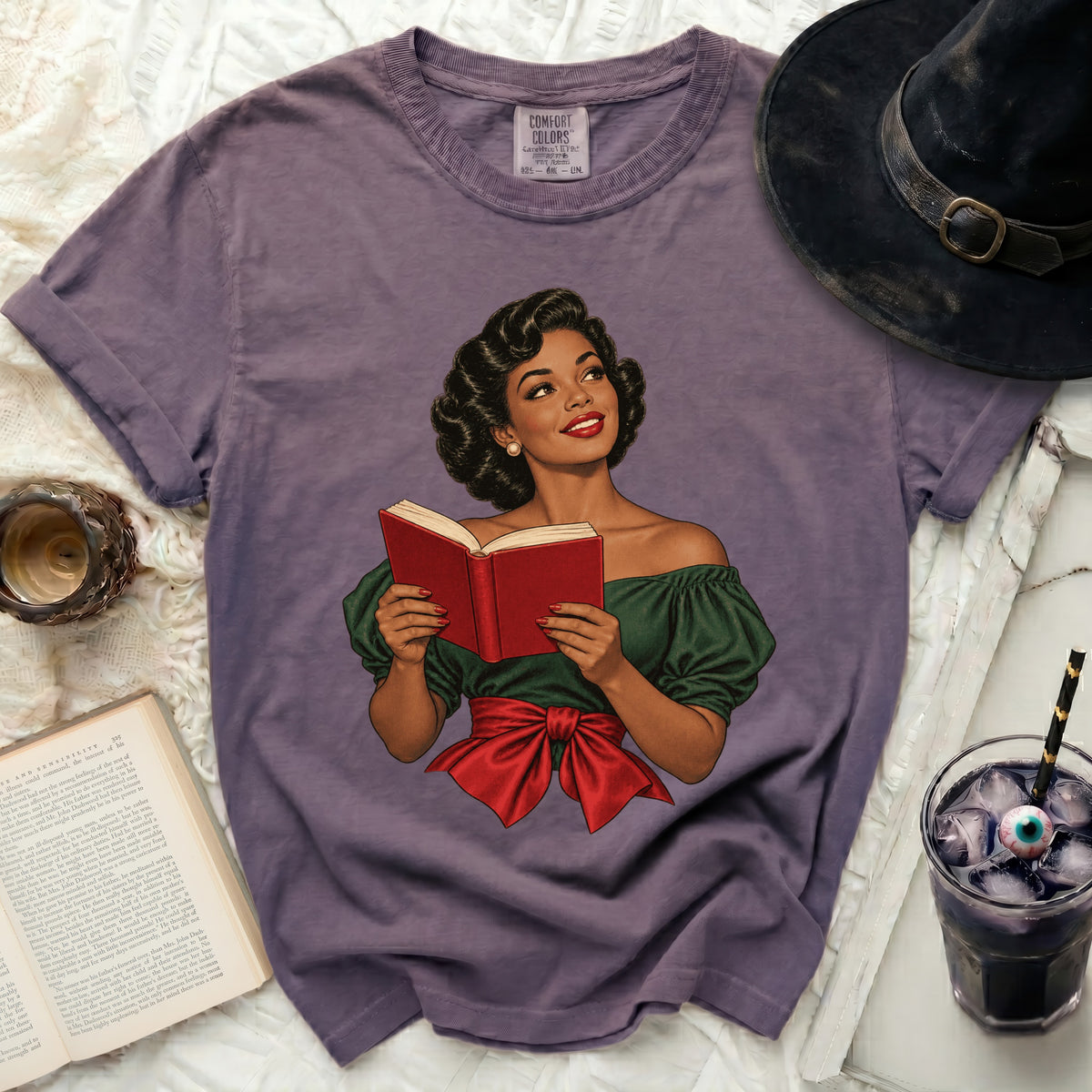 Graphic tee with a vintage illustration of a woman reading a book.