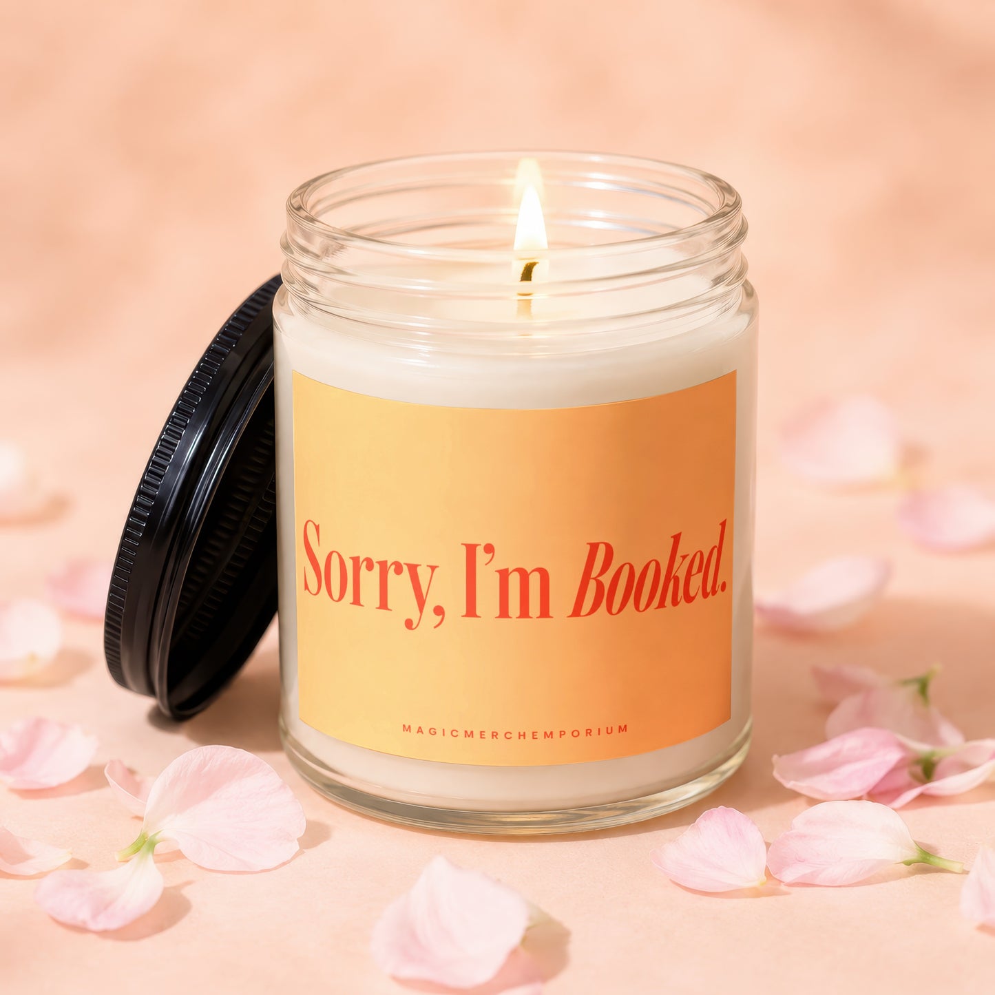 Lit candle with "Sorry, I'm Booked." text on orange label.