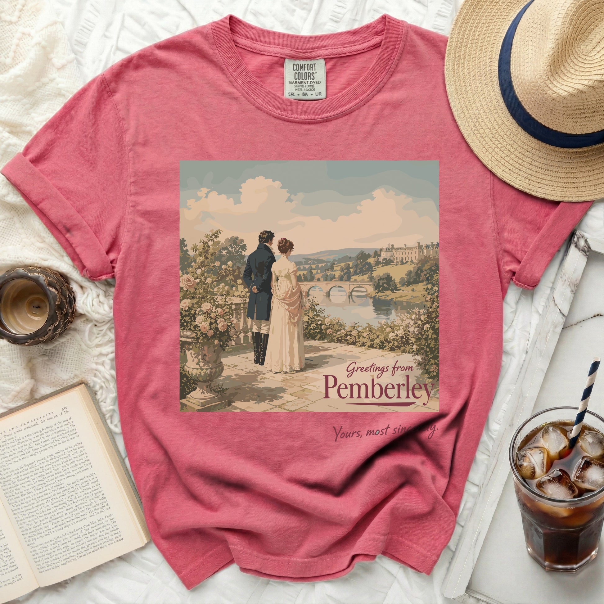 Pink t-shirt with "Greetings from Pemberley" graphic of couple.