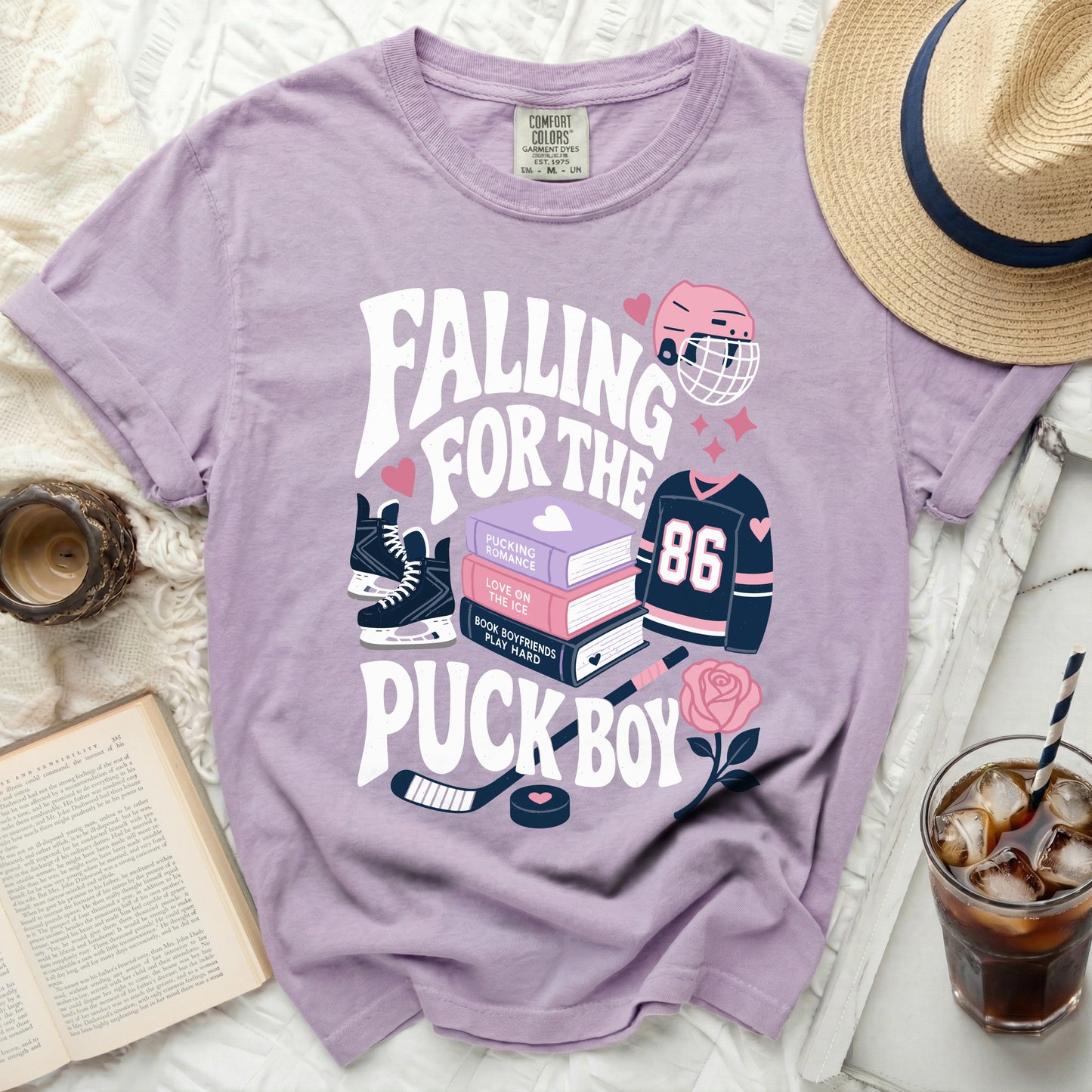 Purple t-shirt with "Falling for the Pucking Romance" hockey theme graphics.