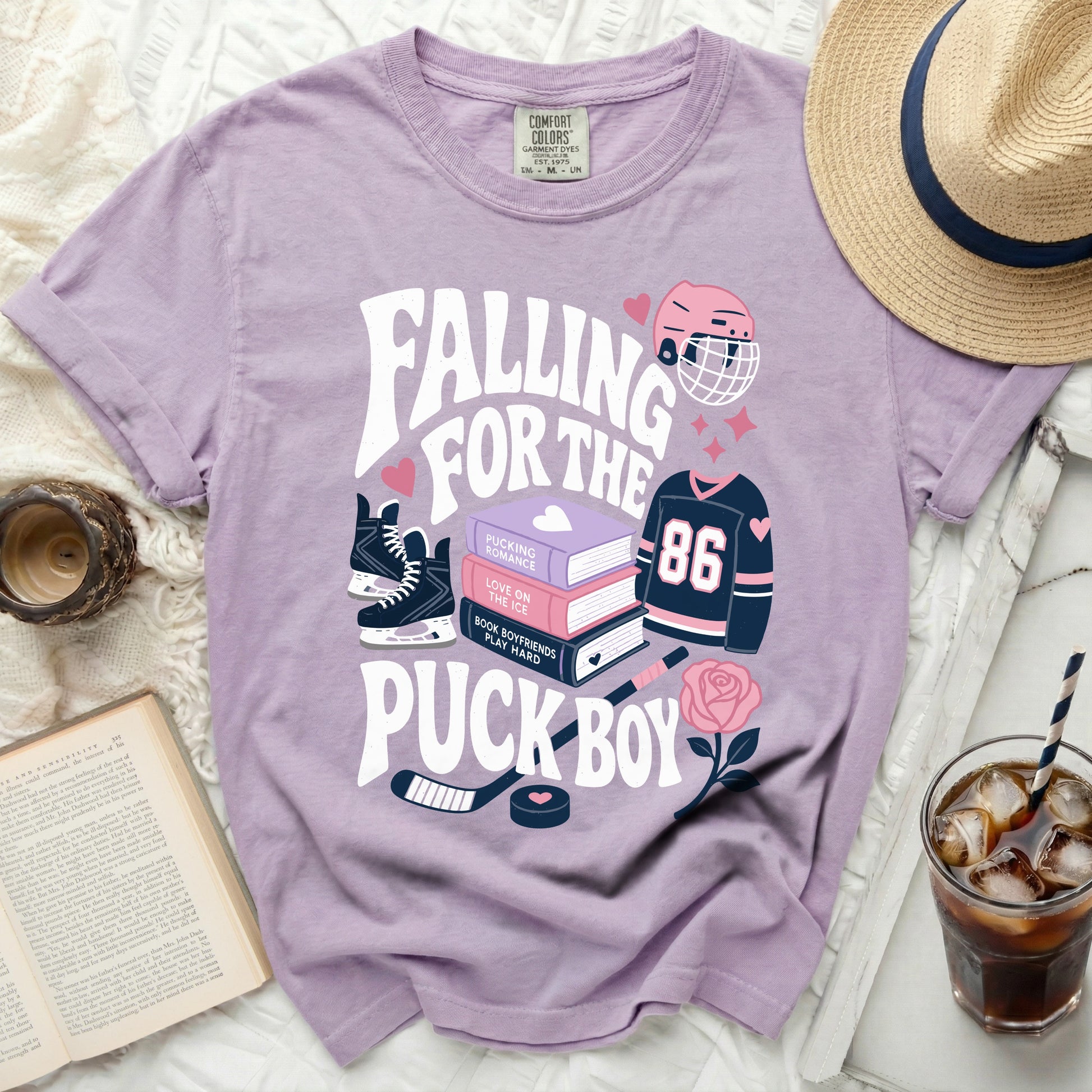 Purple t-shirt with "Falling for the Pucking Romance" hockey theme graphics.