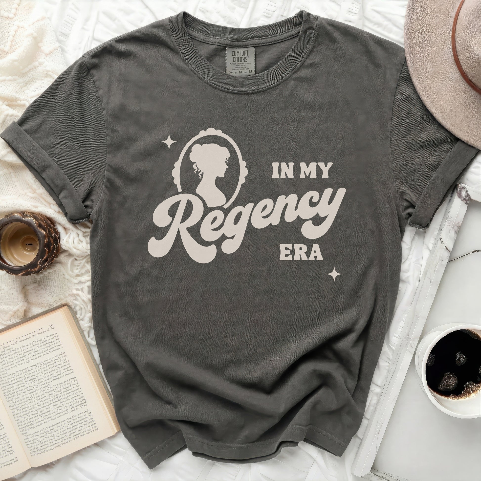 Dark gray t-shirt with "In My Regency Era" text and cameo graphic.