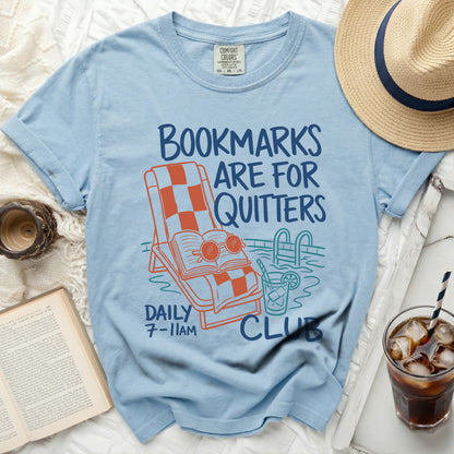 Light blue t-shirt with "Bookmarks Are For Quitters" graphic and pool scene.