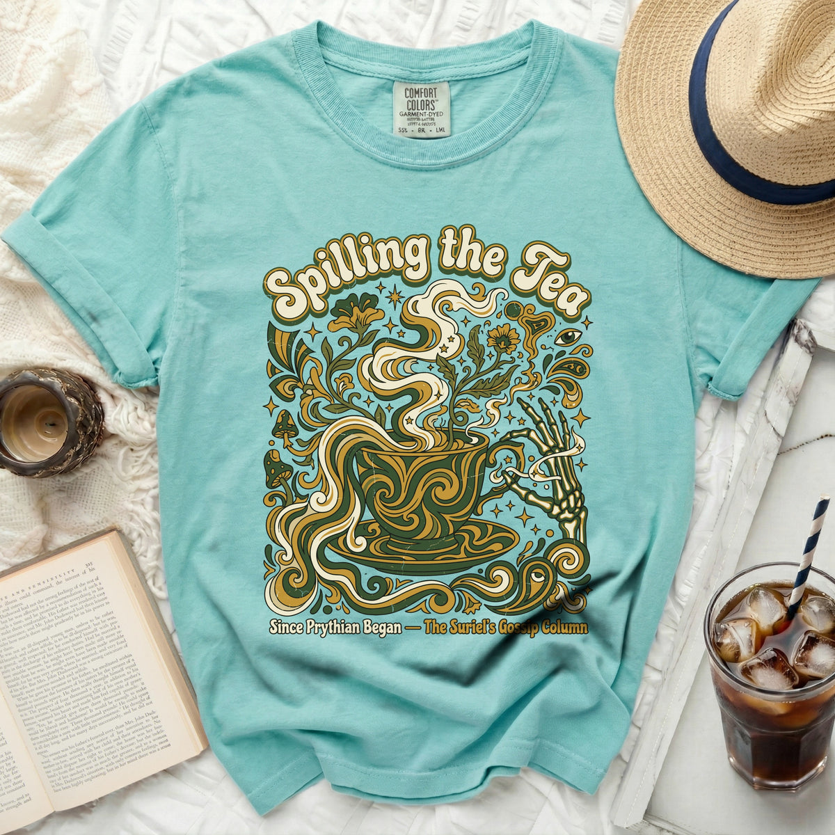 Teal t-shirt with "Spilling the Tea" graphic and skeleton hand.