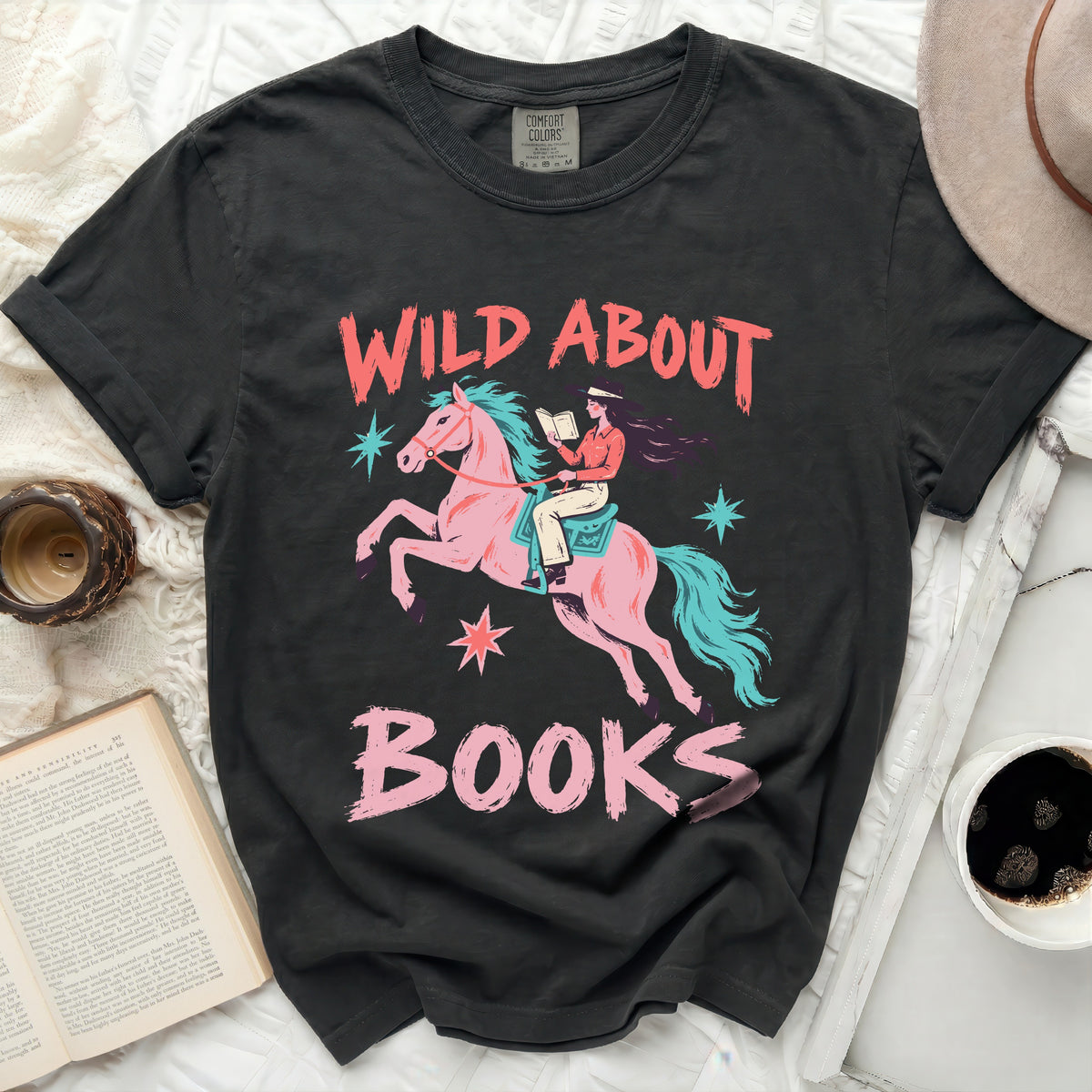 Dark t-shirt with "Wild About Books" text and graphic of person riding horse and reading.