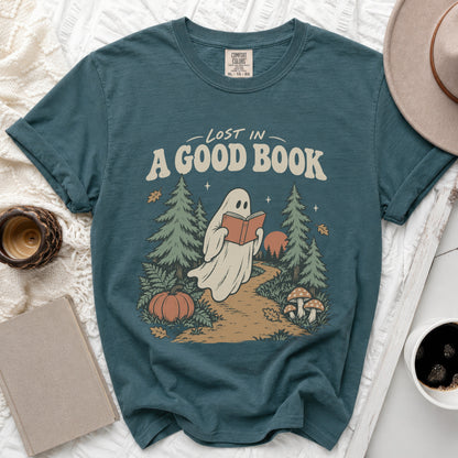 Teal t-shirt with ghost reading a book in a forest, text "Lost in A Good Book".
