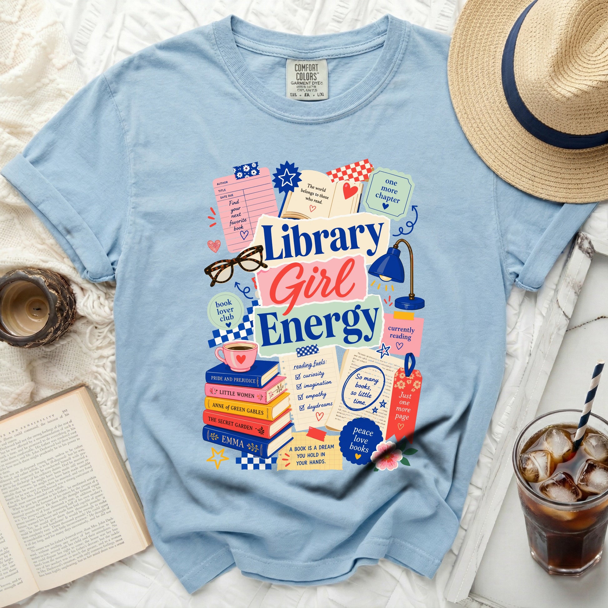 Light blue t-shirt with "Library Girl Energy" graphic, books, and reading-themed icons.