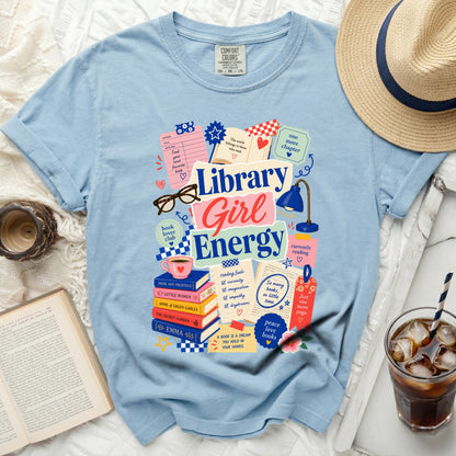 Light blue t-shirt with "Library Girl Energy" graphic, books, and reading-themed icons.