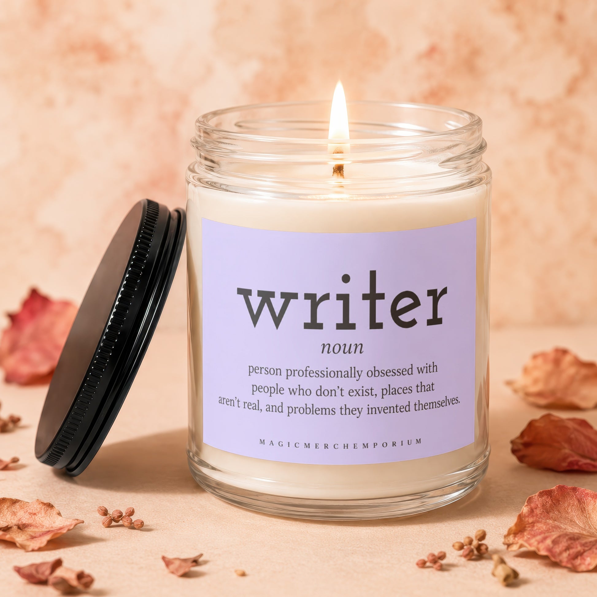Lit candle in glass jar with "writer" definition label and black lid.