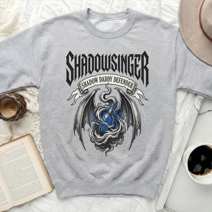 Grey sweatshirt with "Shadowsinger Shadow Daddy Defender" graphic.