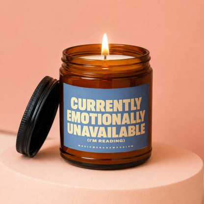 Amber candle with lit wick and "Currently Emotionally Unavailable (I'm Reading)" text.