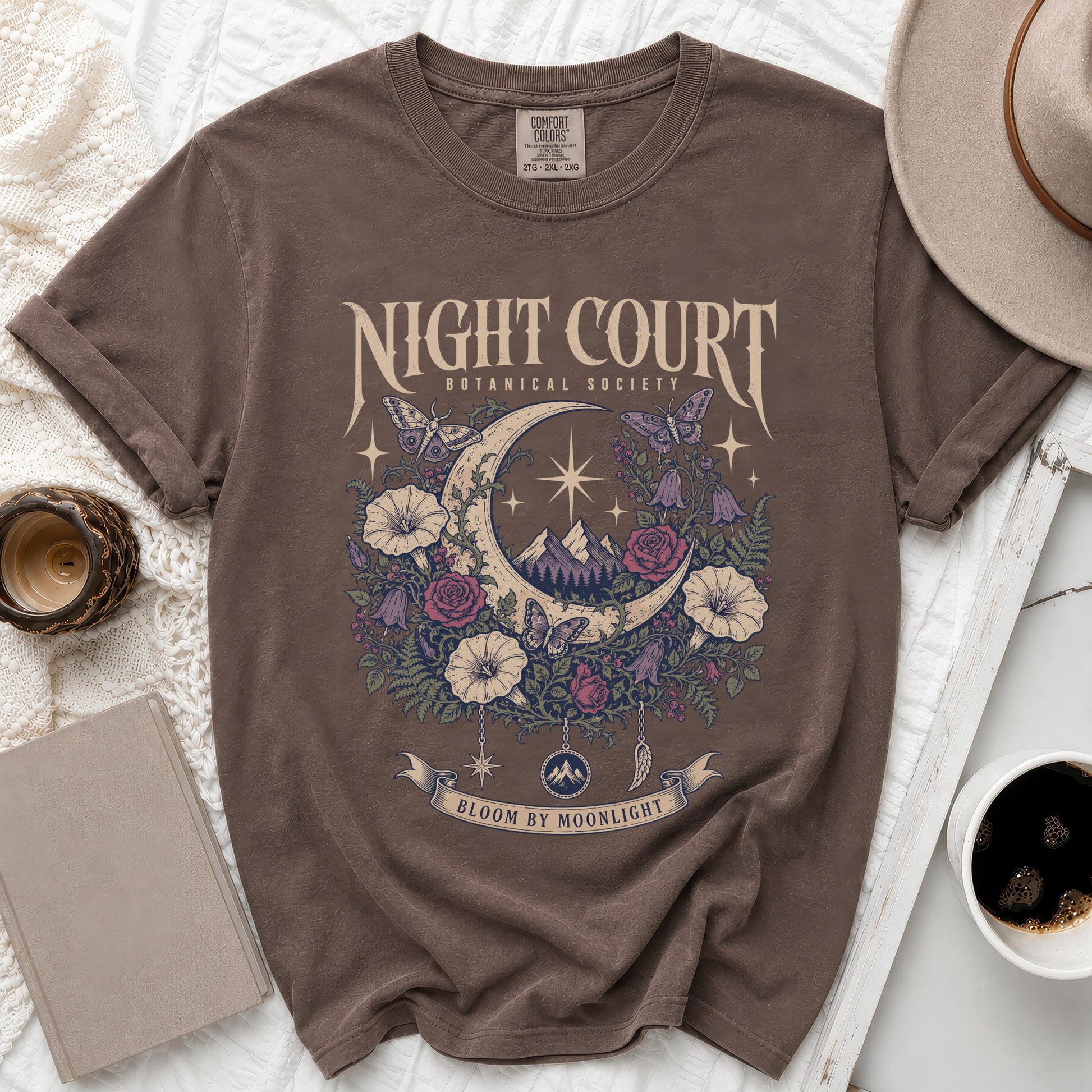 Brown t-shirt with "Night Court Botanical Society Bloom by Moonlight" graphic.