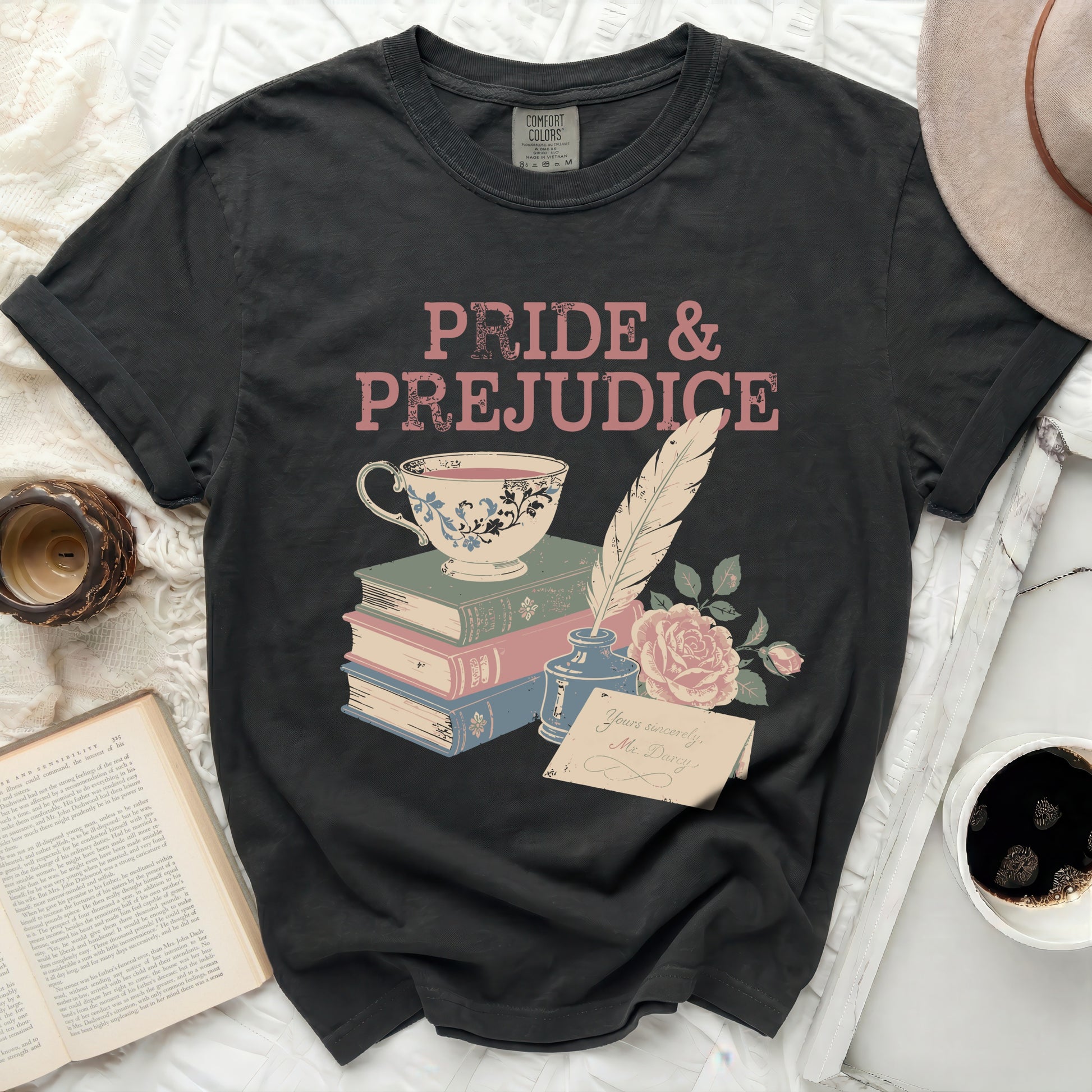 Black t-shirt with Pride & Prejudice text, teacup, books, quill, and rose.