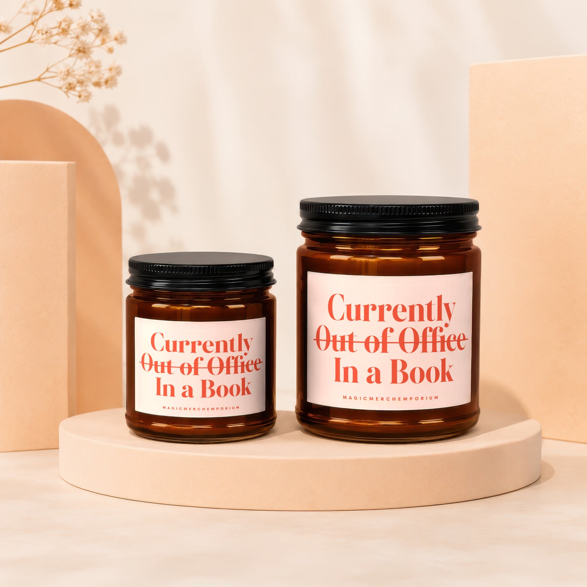 Two amber glass jars with black lids, featuring labels that say "Currently Out of Office In a Book."