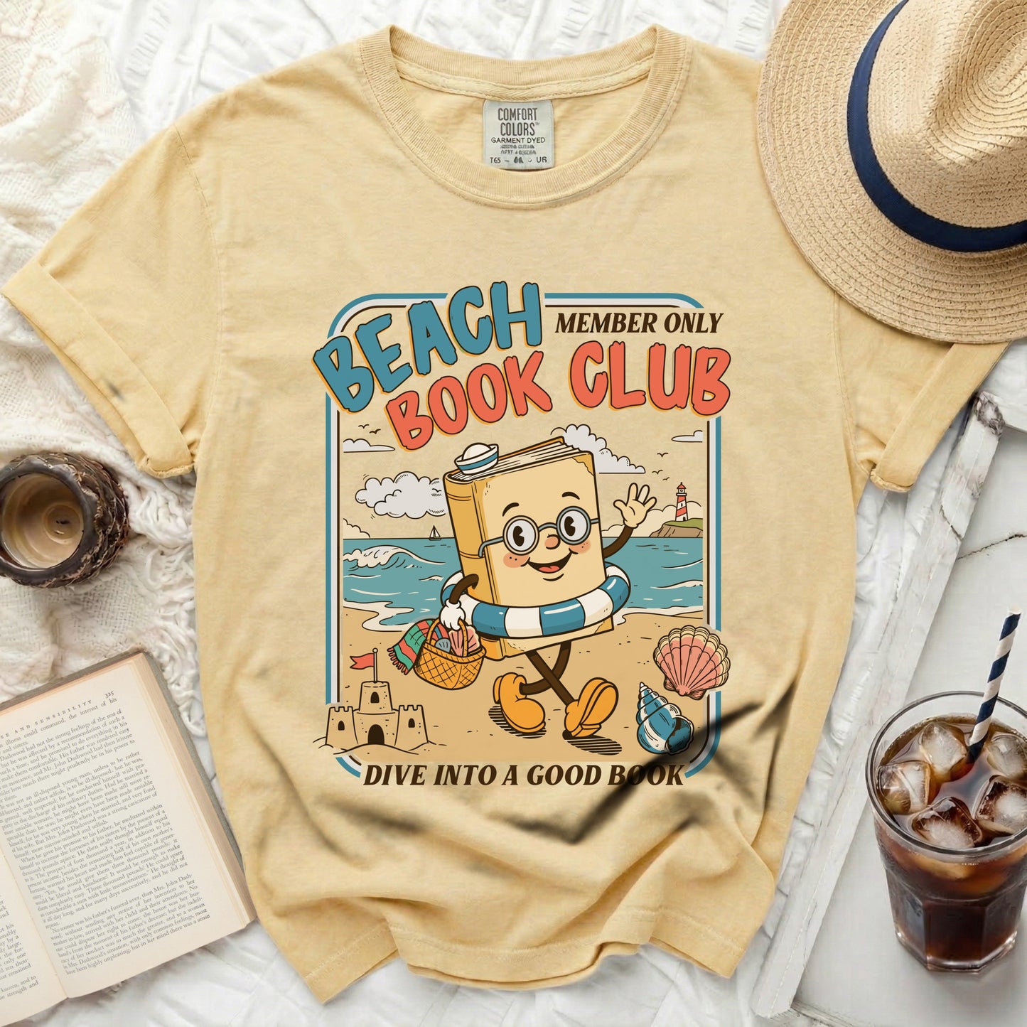 Yellow t-shirt with "Beach Book Club" cartoon of a book on the beach.