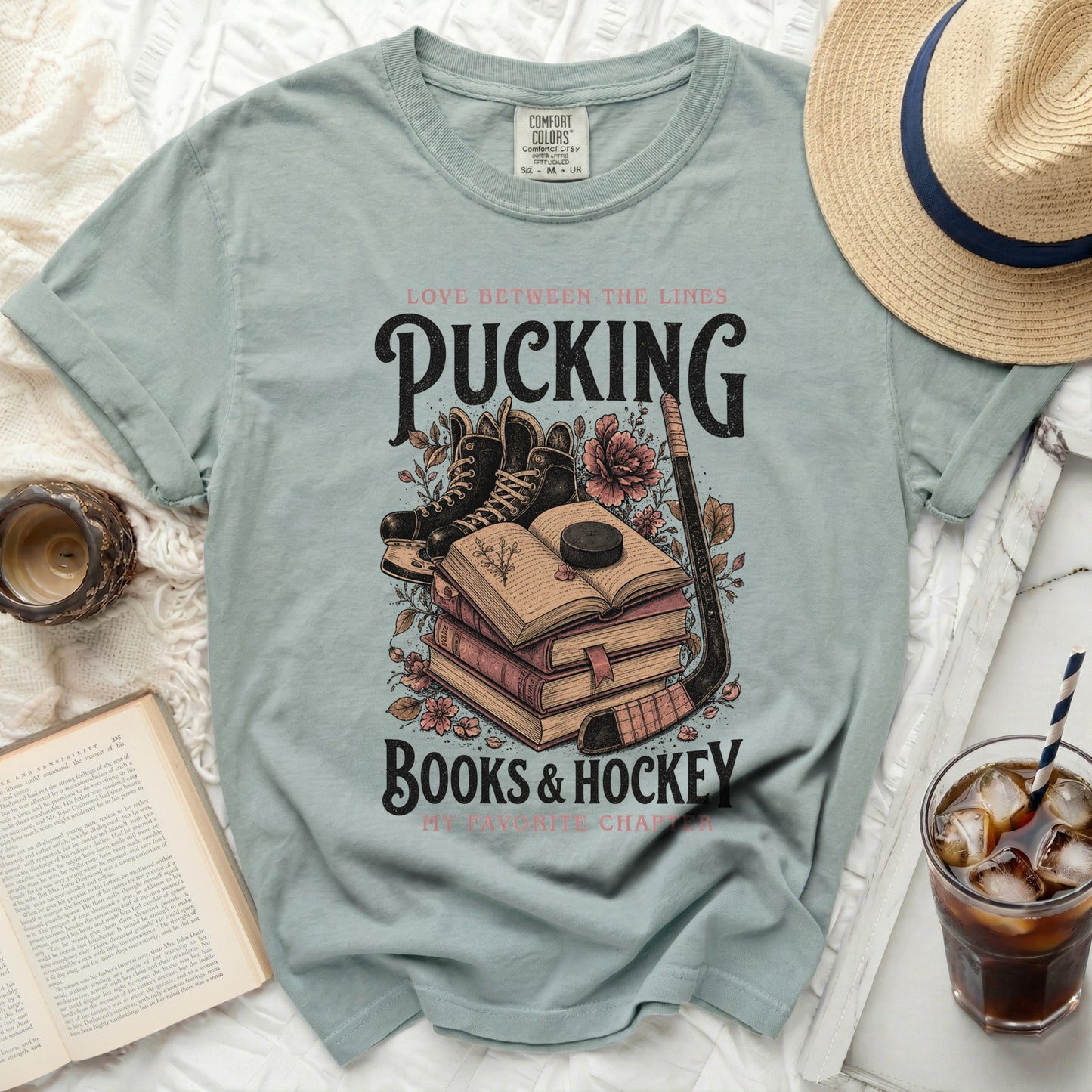 Green t-shirt with "Pucking Books & Hockey" and hockey gear.