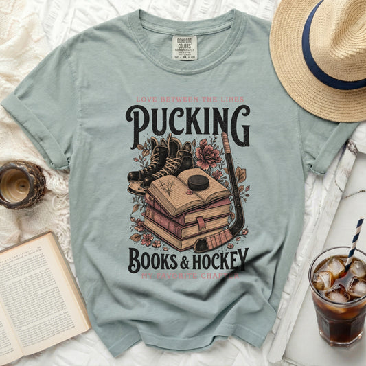 Green t-shirt with "Pucking Books & Hockey" and hockey gear.