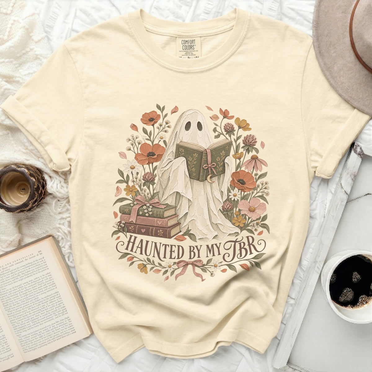 Cream t-shirt with ghost reading surrounded by flowers and text "Haunted by my TBR".