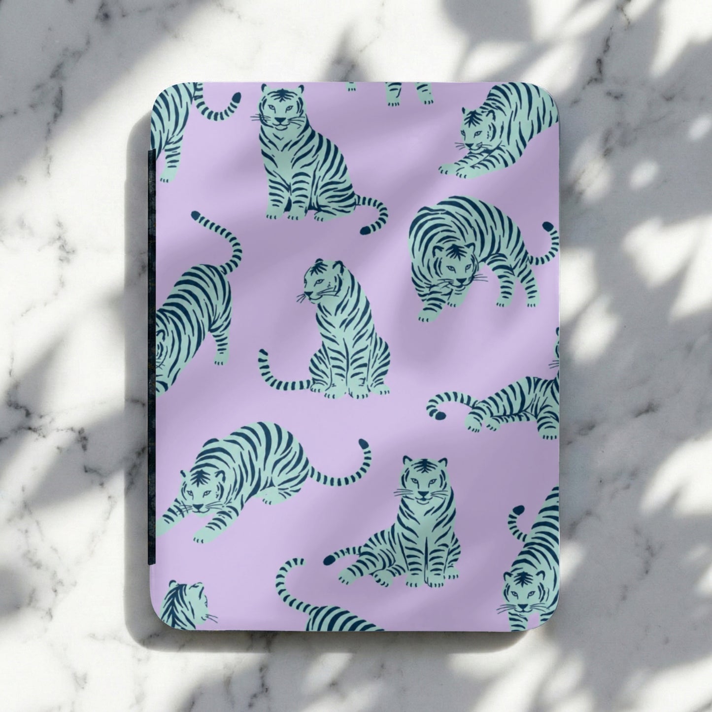 Purple notebook with a repeating pattern of teal tigers in various poses.