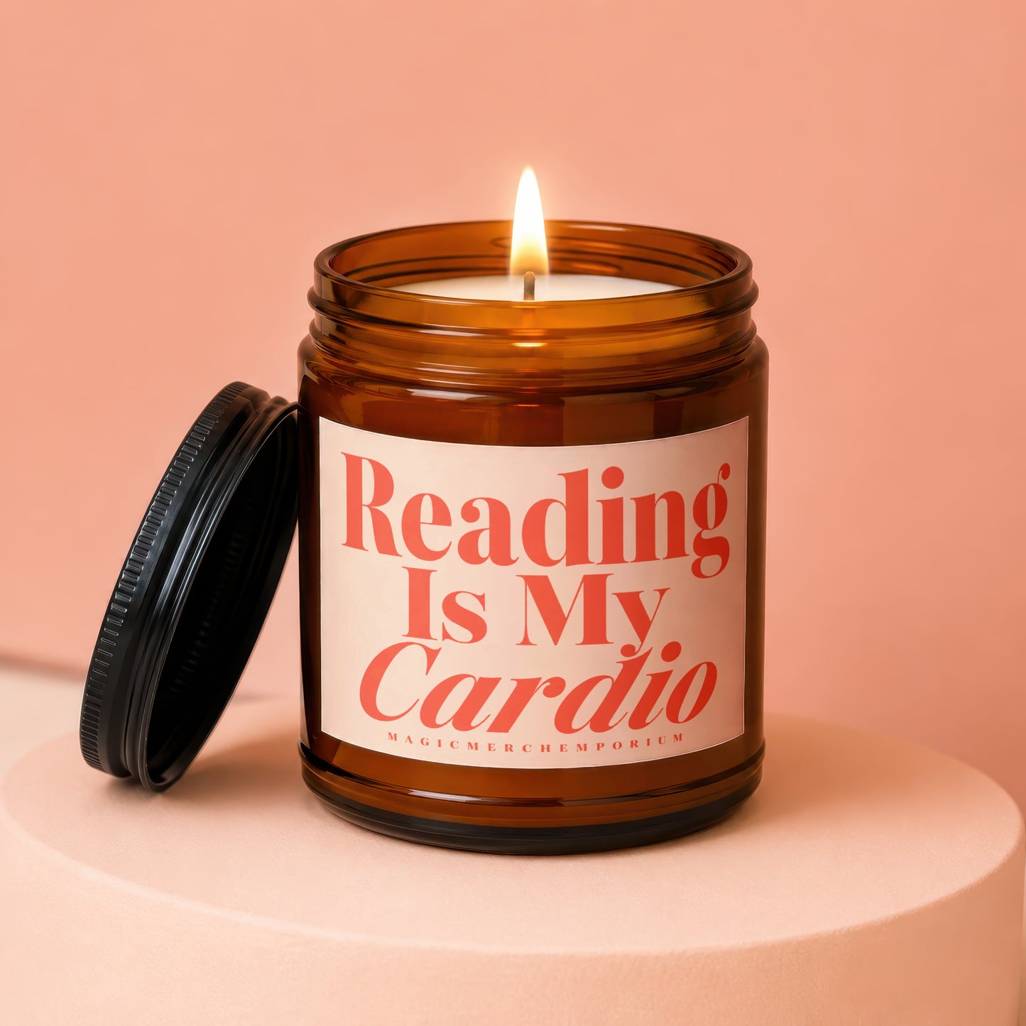 Amber jar candle with lit wick and lid off, saying "Reading Is My Cardio".