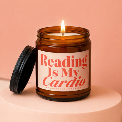 Amber jar candle with lit wick and lid off, saying "Reading Is My Cardio".