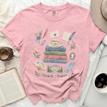Pink t-shirt with Jane Austen book stack and accessories graphic.