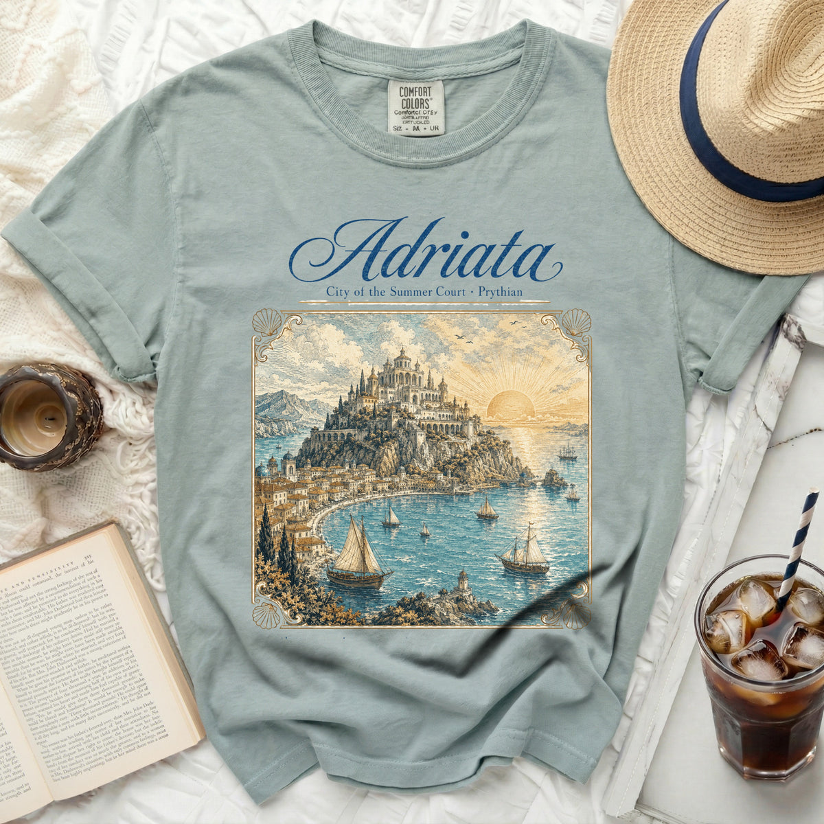 T-shirt with "Adriata City of the Summer Court" graphic and coastal illustration.