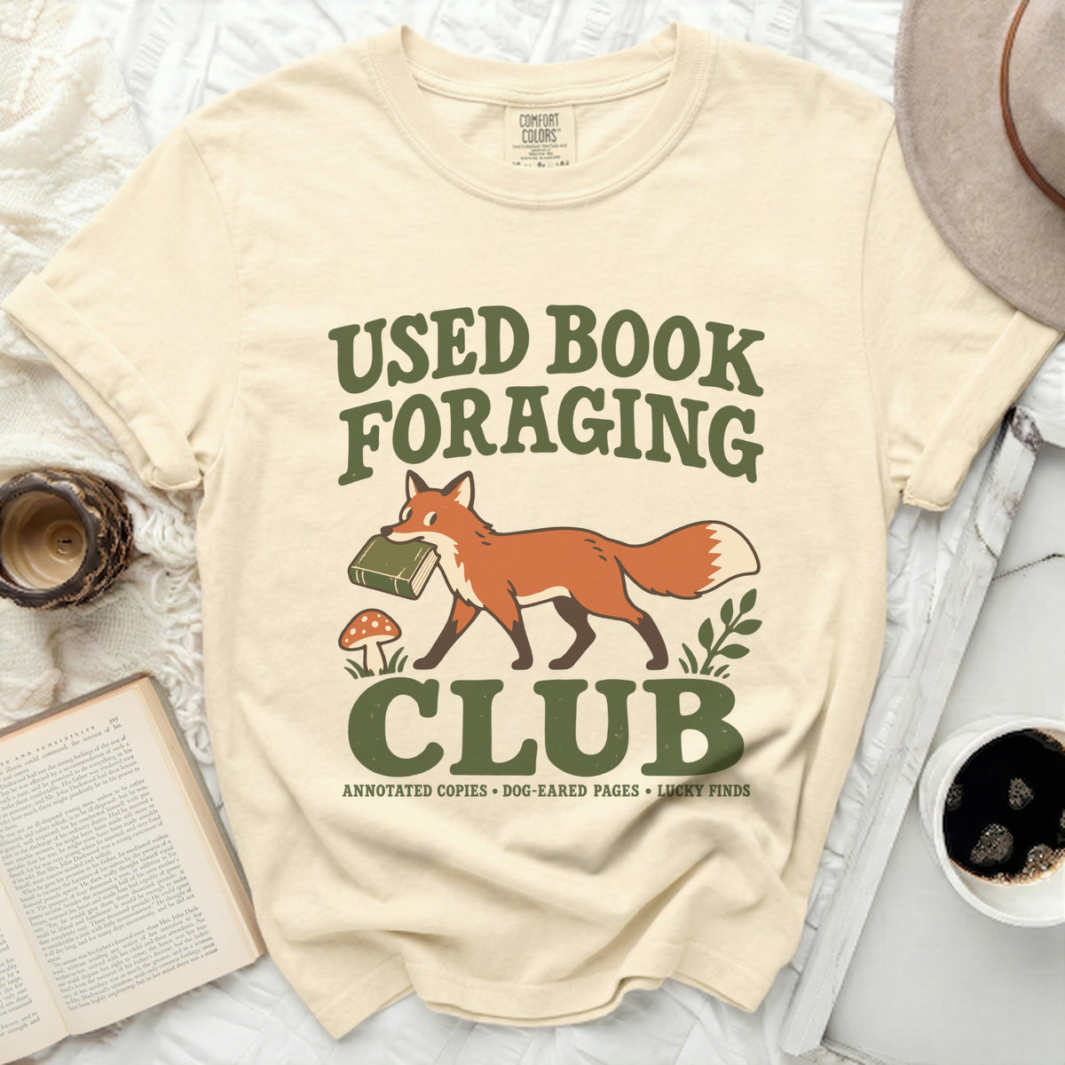 Cream t-shirt with "Used Book Foraging Club" text and a fox carrying a book.