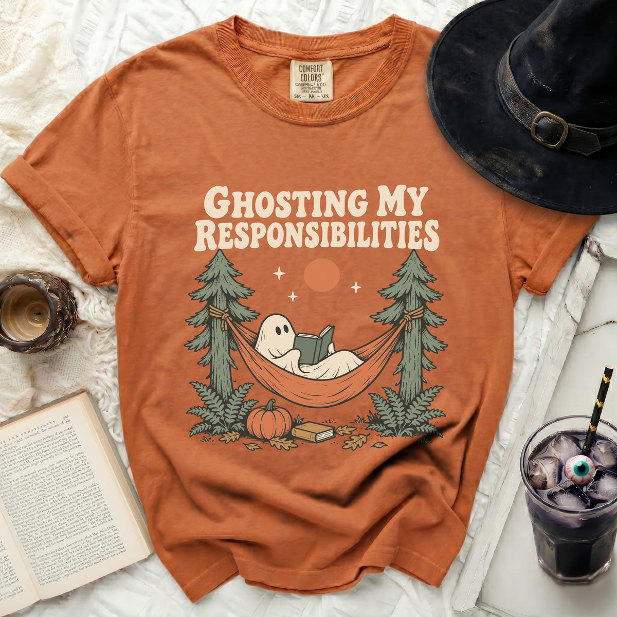 Orange t-shirt with ghost reading in a hammock and text "Ghosting My Responsibilities".
