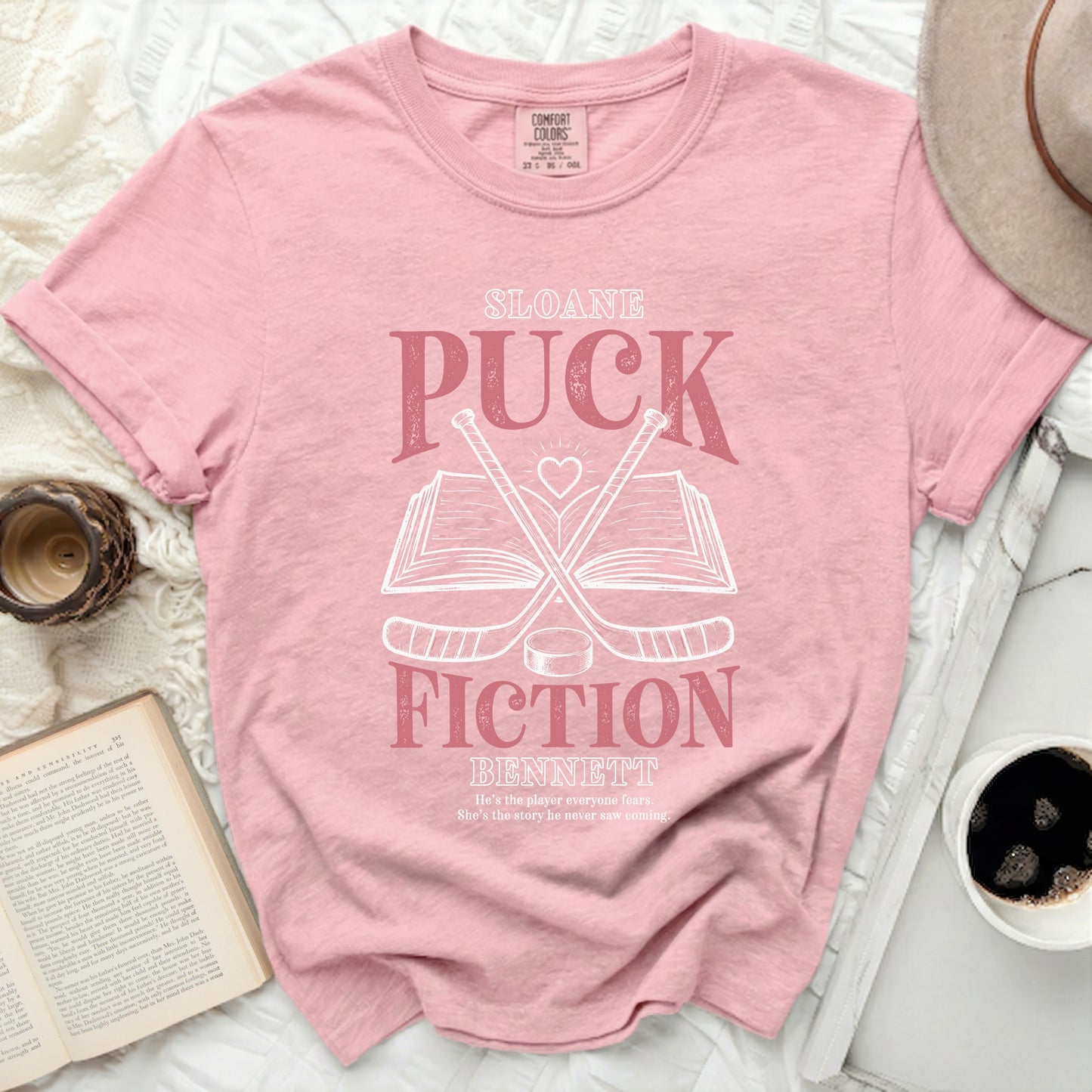 Pink t-shirt with "Sloane, Puck, Bennett: He's the player everyone fears. She's the story he never saw coming."