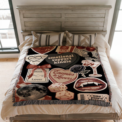 a bedroom with a bed covered in a colorful, patterned blanket that includes various objects such as a heart, a rose, a book, and a wine glass.