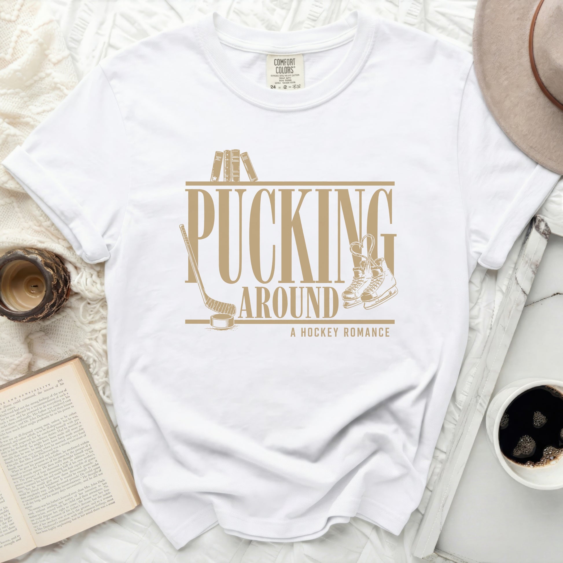 White t-shirt with "Pucking Around A Hockey Romance" text and graphics.
