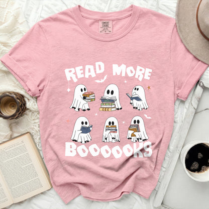 Pink t-shirt with white ghosts reading books and the text "READ MORE BOOOOOKS".