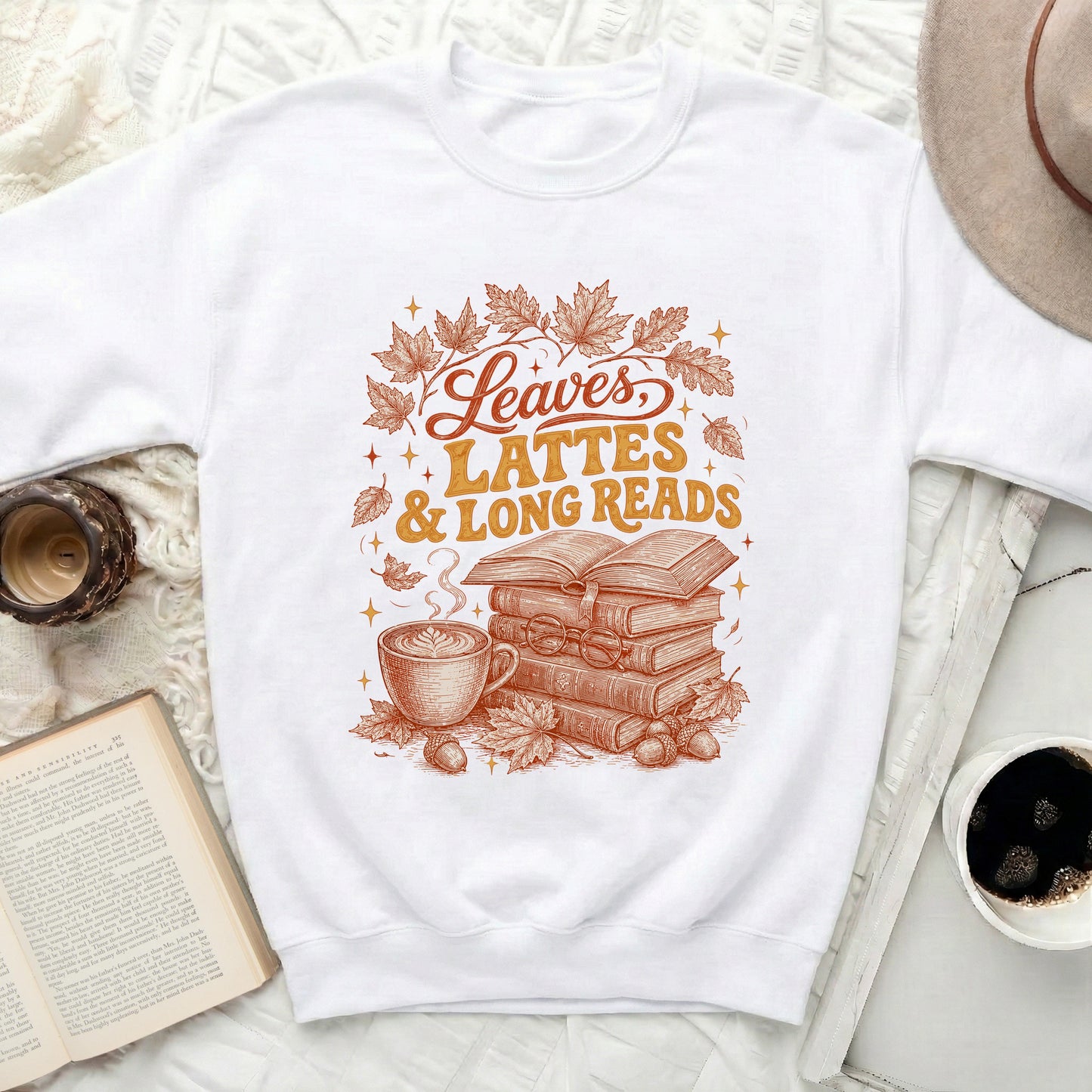 White sweatshirt with "Leaves, Lattes & Long Reads" graphic.