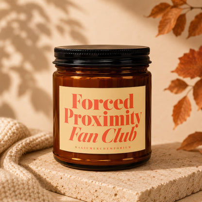 Amber glass candle with label reading "Forced Proximity Fan Club" and "MagicMerchEmporium".