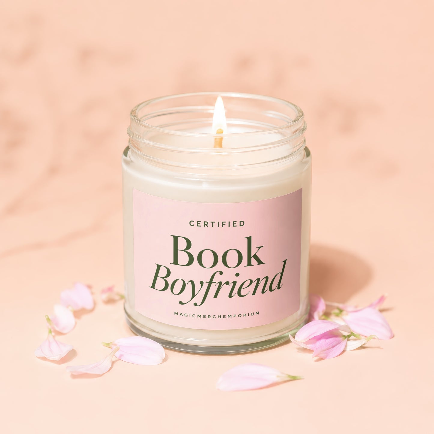 Glass jar candle with pink label that reads "CERTIFIED Book Boyfriend" and "MAGICMERCH”.