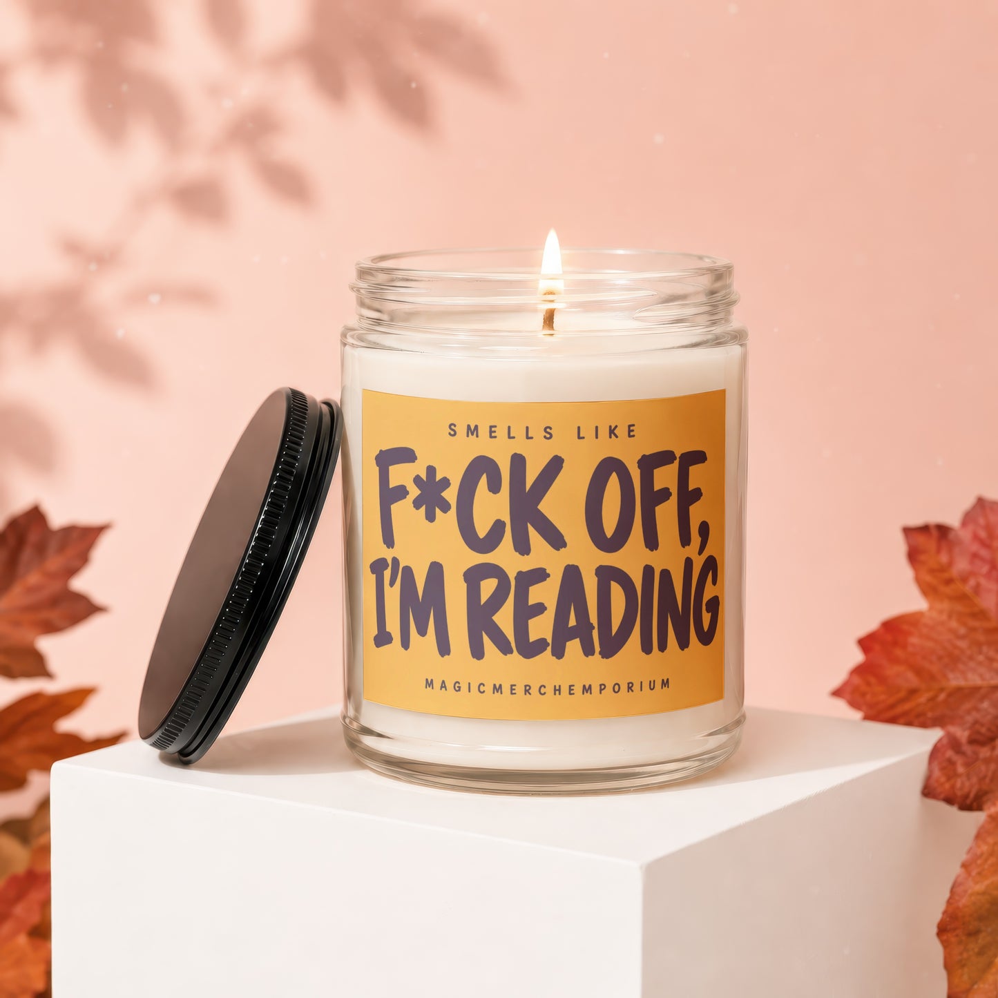 Candle with "F*ck Off, I'm Reading" text and lid off.