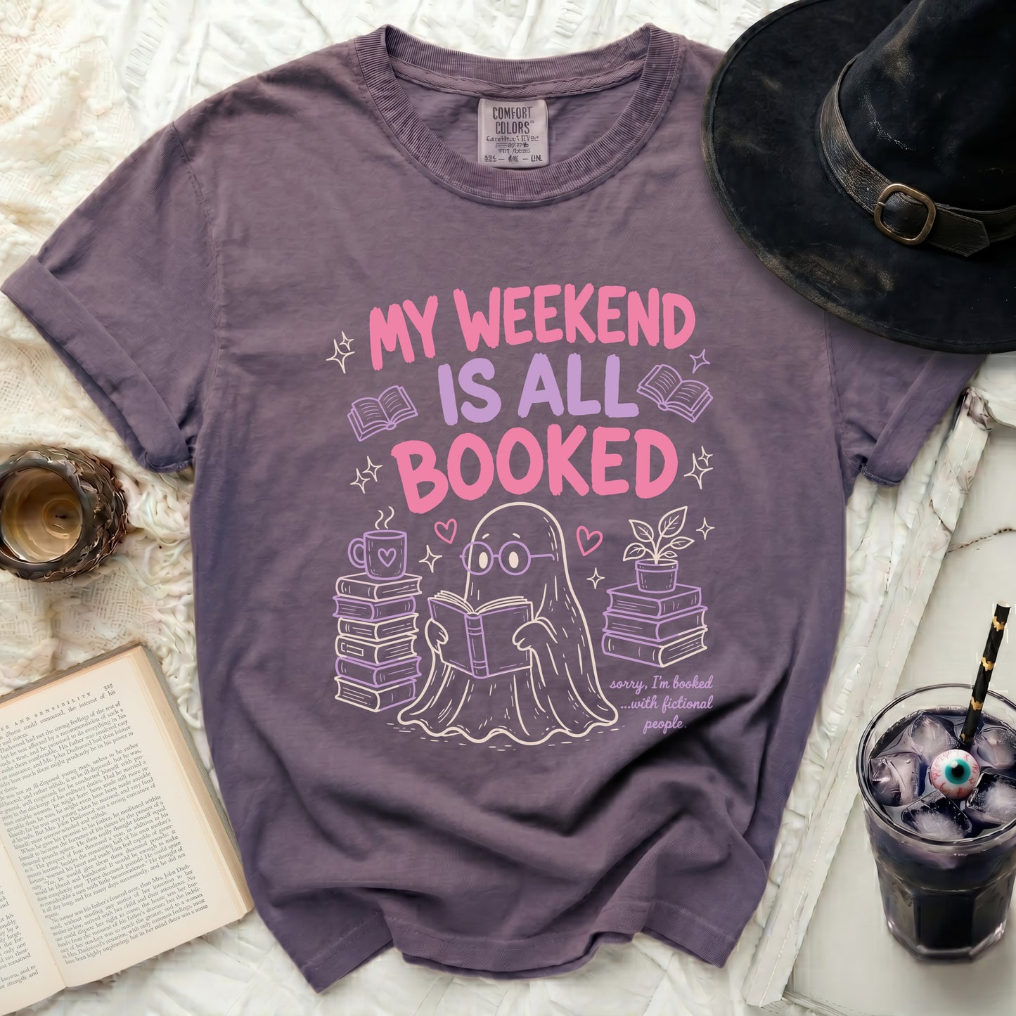 Purple t-shirt with a ghost reading surrounded by books and text.