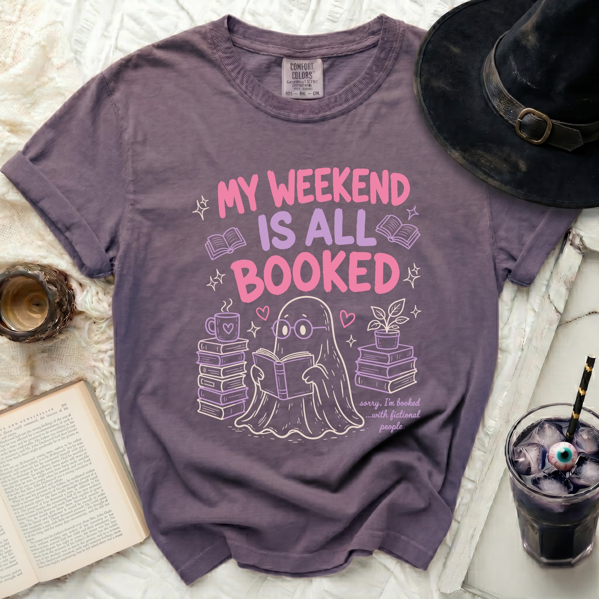 Purple t-shirt with a ghost reading surrounded by books and text.