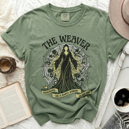 Green t-shirt with "The Weaver" and spiderweb design, "Middengard She is Always Spinning Do Not Run".