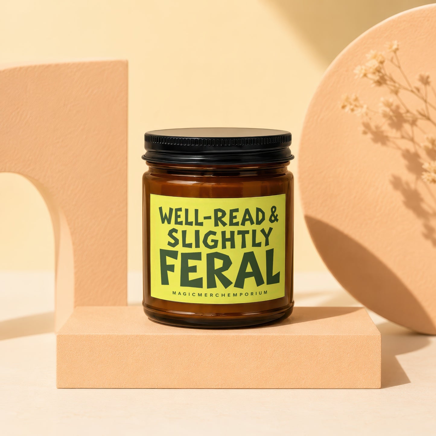 Amber jar candle with black lid reads "Well-Read & Slightly Feral."