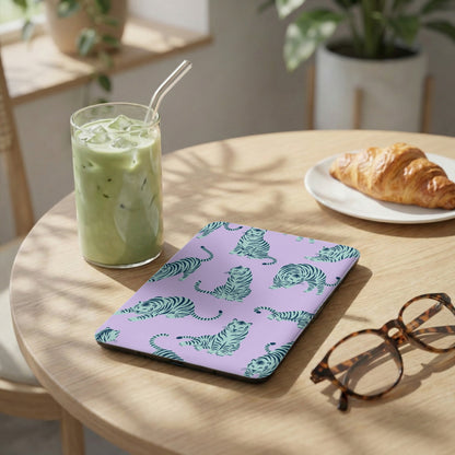 Lavender notebook with teal tiger pattern beside iced matcha and croissant.