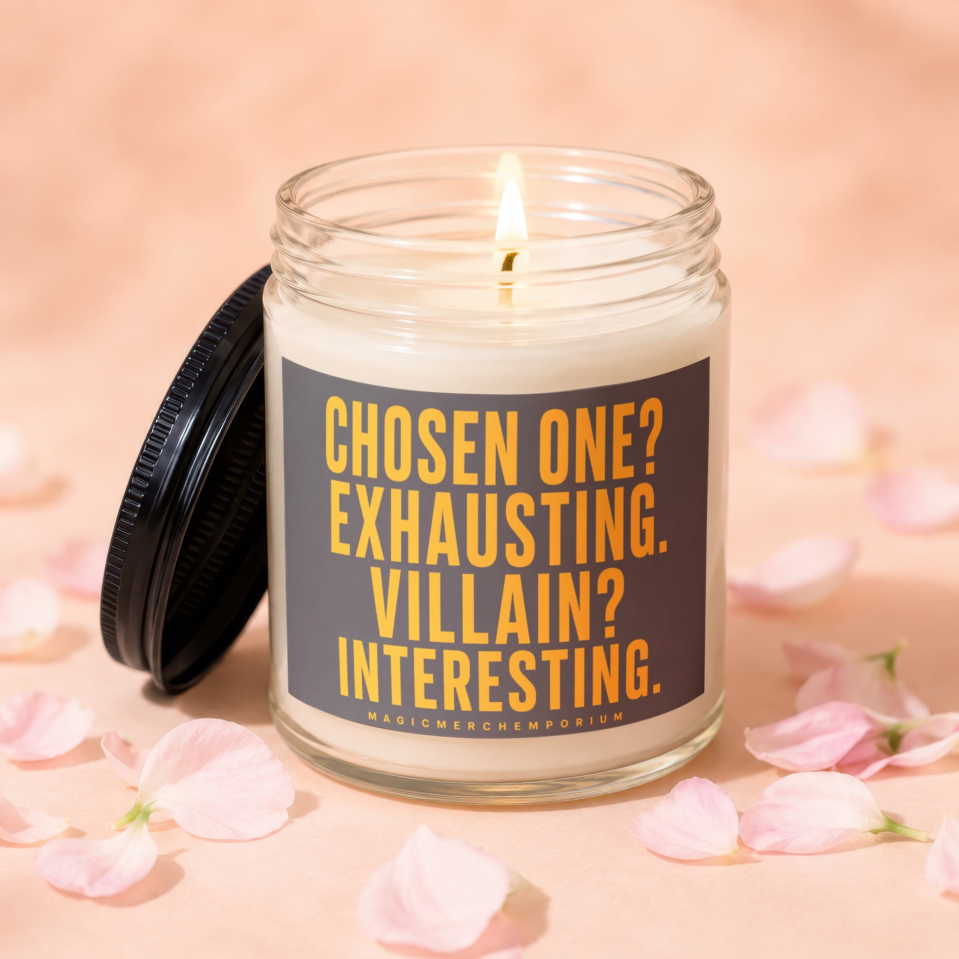 Lit jar candle with black lid, featuring text "Chosen One? Exhausting. Villain? Interesting."