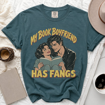 Teal t-shirt with vintage comic art of a couple reading, "My Book Boyfriend Has Fangs."