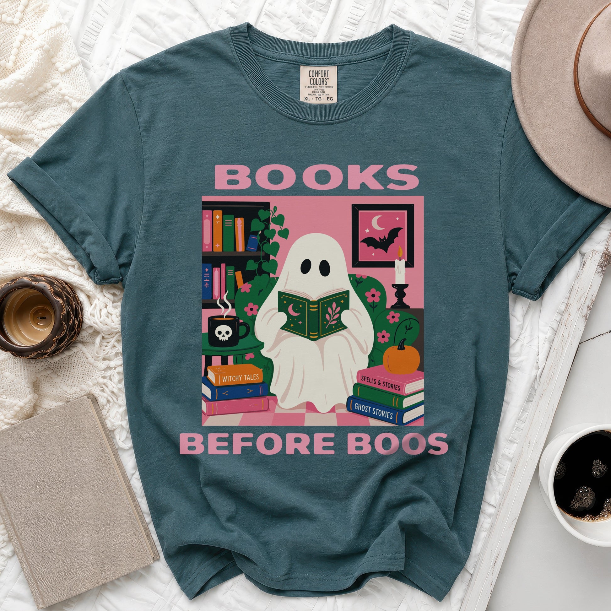 Teal t-shirt graphic: ghost reading books, text "BOOKS BEFORE BOOS".