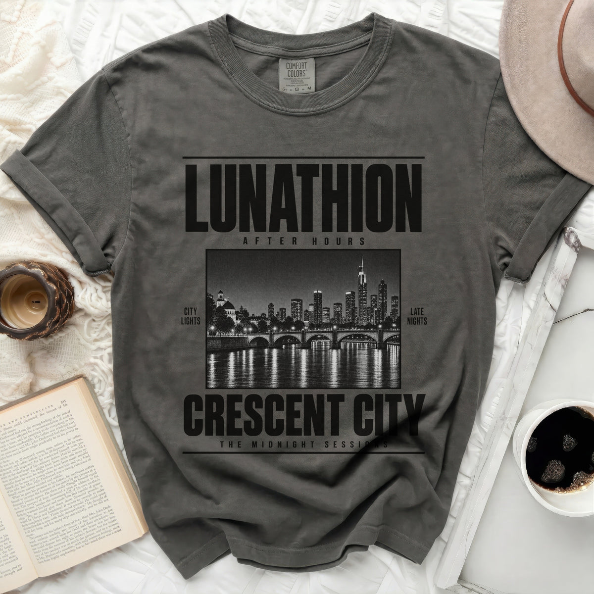 Comfort Colors t-shirt with "LUNATHION AFTER HOURS CRESCENT CITY" text and cityscape graphic.