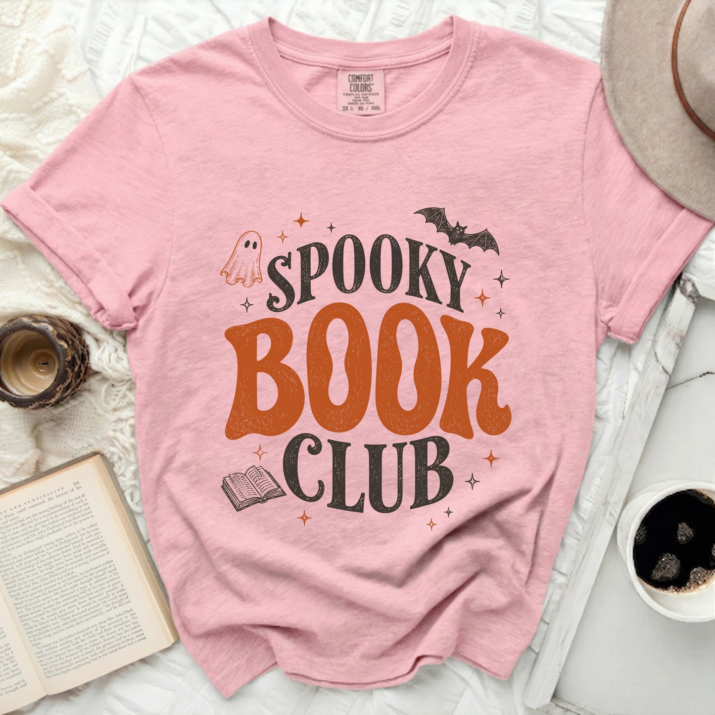 Pink t-shirt with "Spooky Book Club" Halloween graphic.