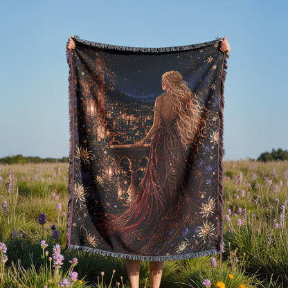 A person holds up a large tapestry featuring a woman with long, flowing hair and a flowing dress, standing in a field of purple flowers.